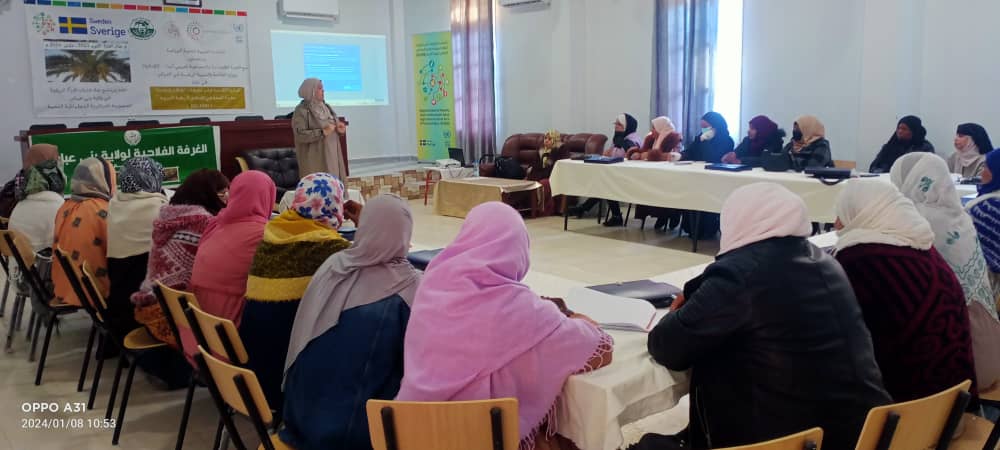 Woman speaker in front of women attendees