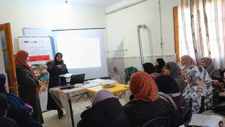 Woman speaker in front of women attendees.