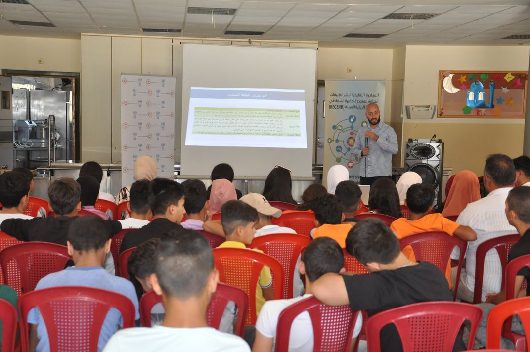 Man lecturing in front of youth