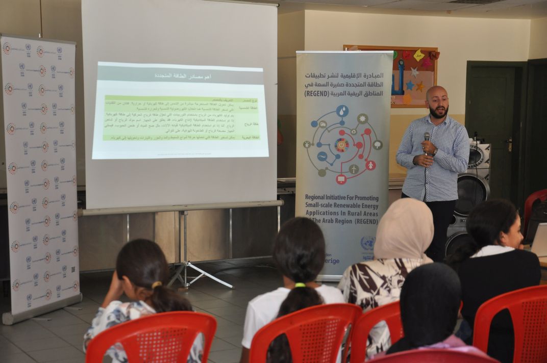 Man lecturing in front of youth