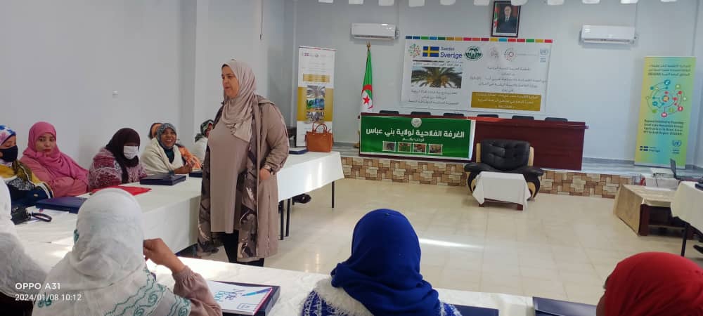 Woman speaker in front of women attendees