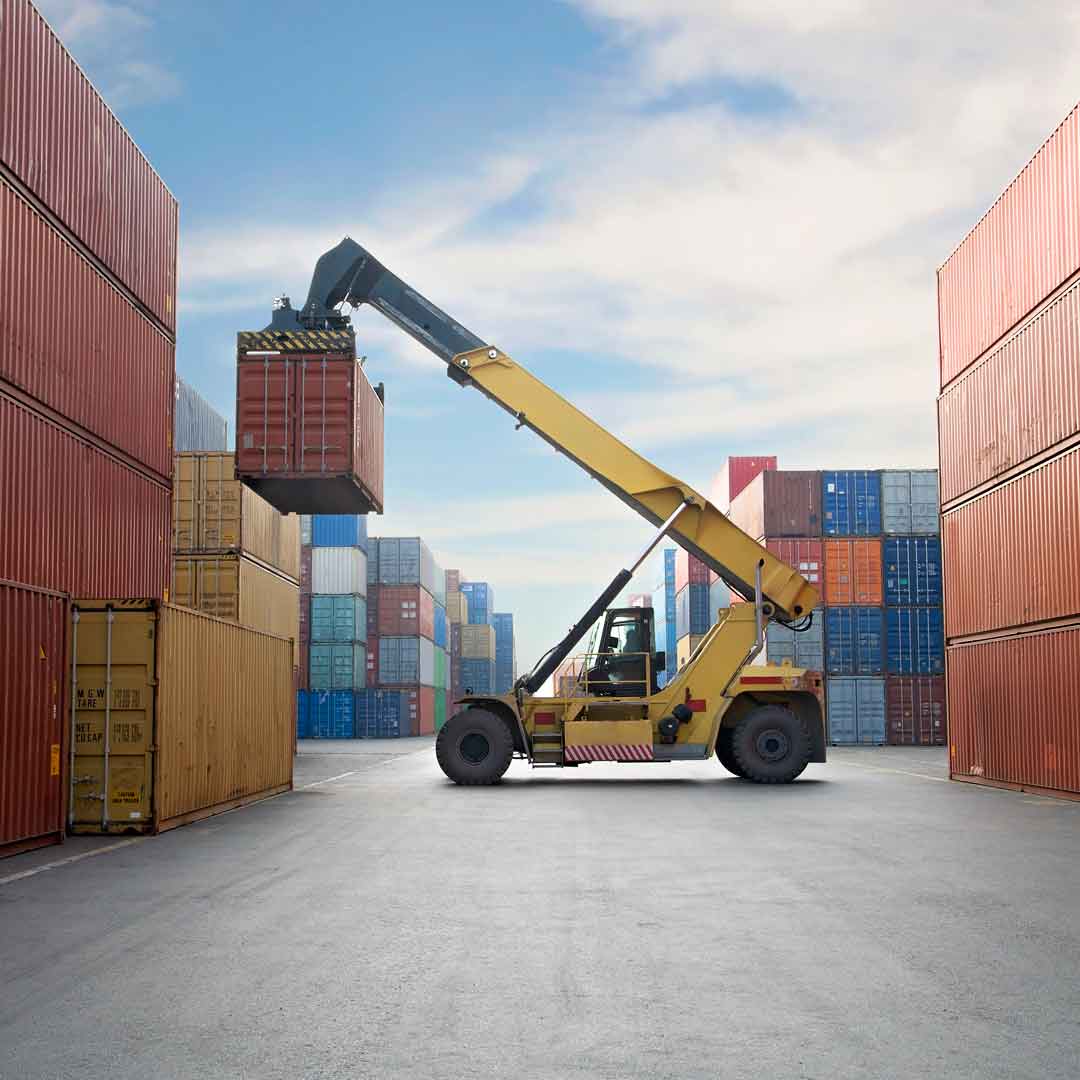 Crane lifting up container in a port. Photo: iStock