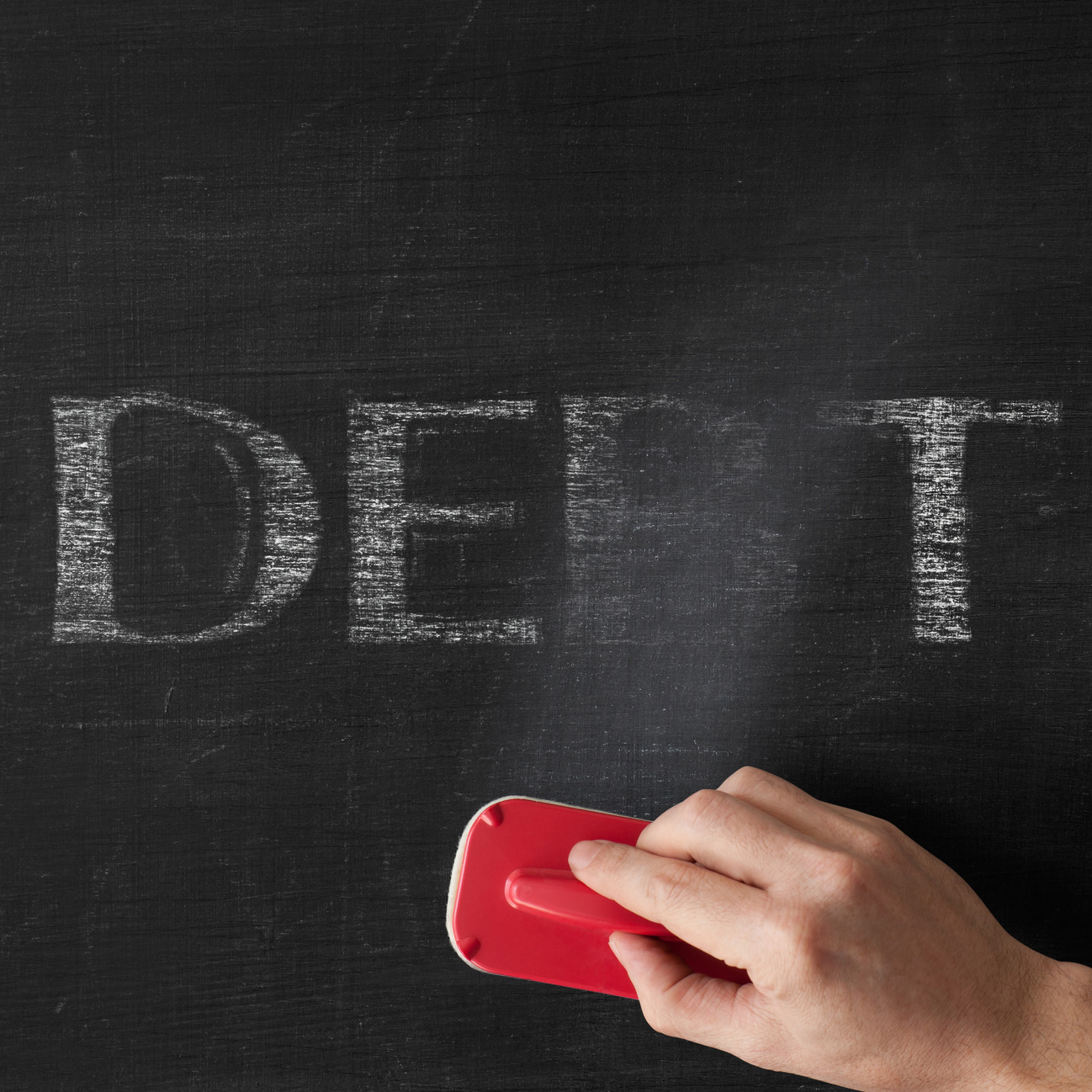 Erasing the word debt off a board. istock image