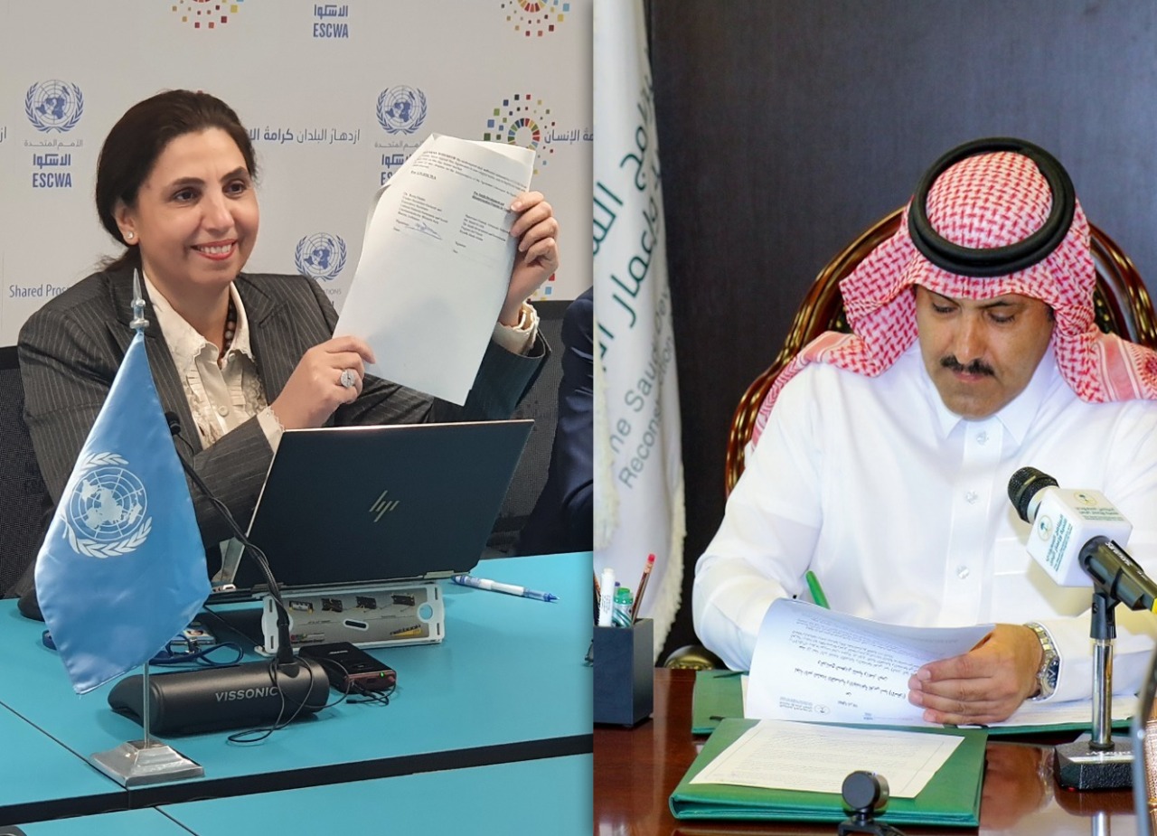 ESCWA Executive Secretary showing signature on agreement, while SDPRY General Supervisor signs on it in a virtual ceremony