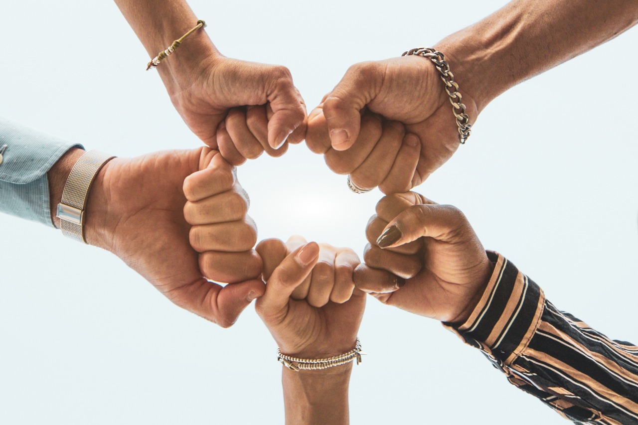 hands held together in a circle of solidarity