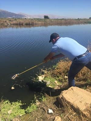 A person cleaning the river