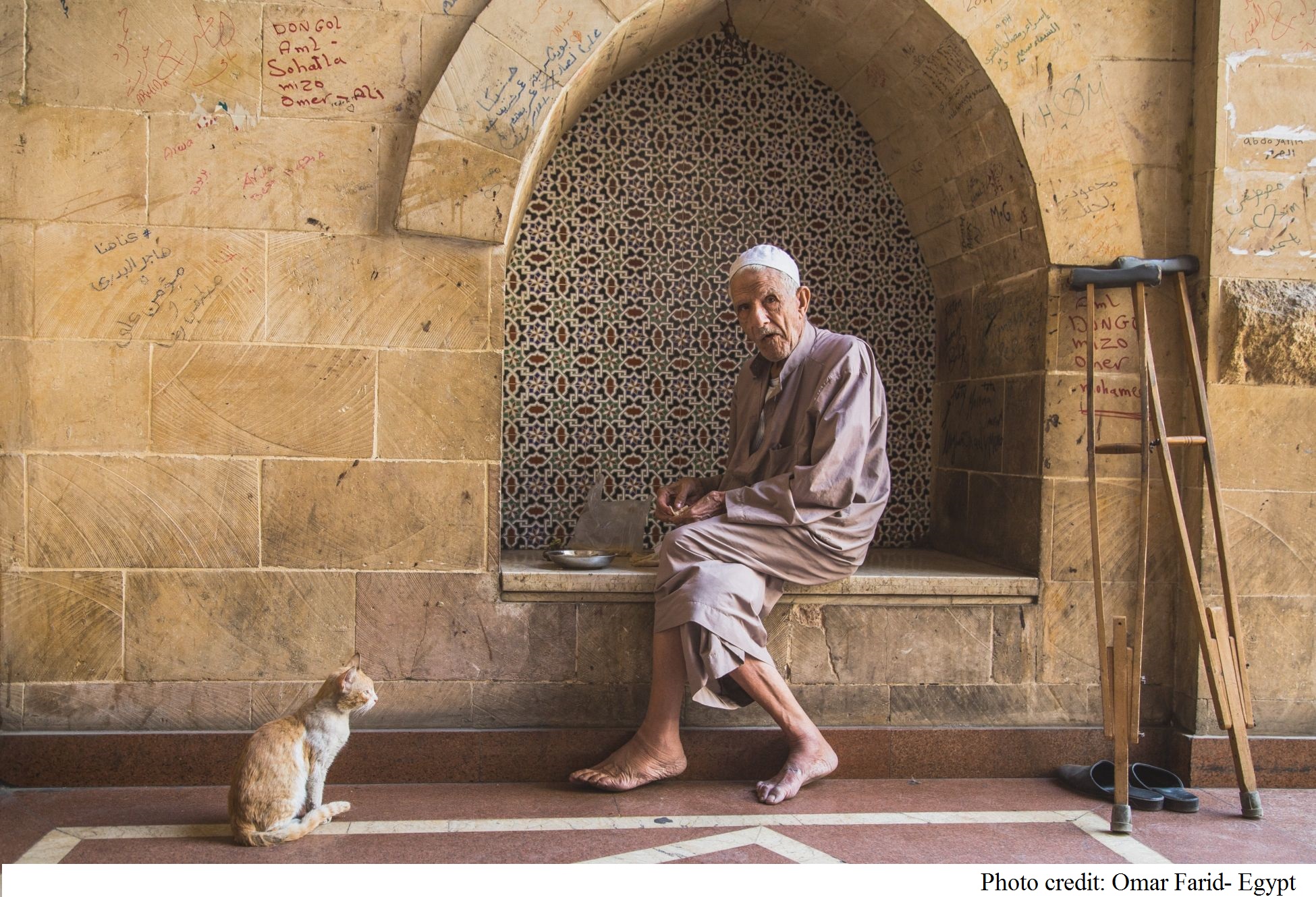 Older person sitting on the street