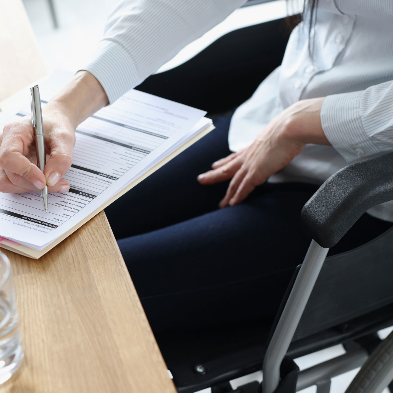 istock image: man in wheelchair filling form