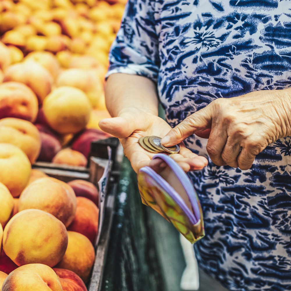 iStock image: woman counting money while shopping