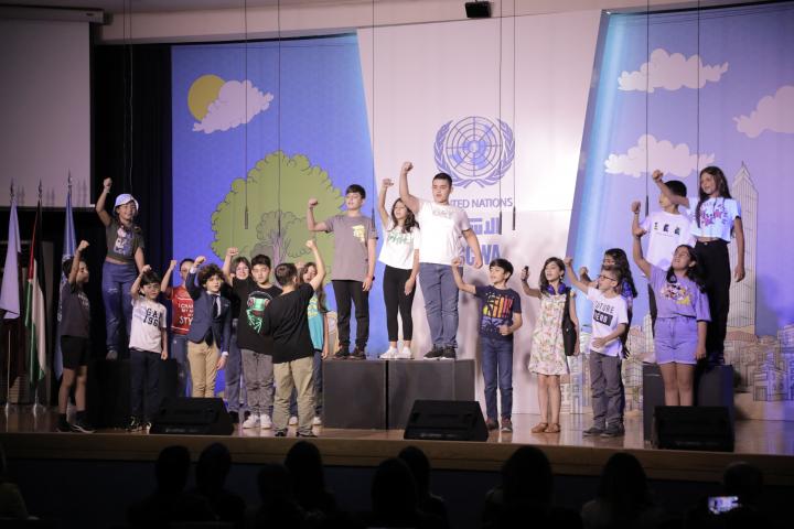 Children on the stage singing ESCWA Song