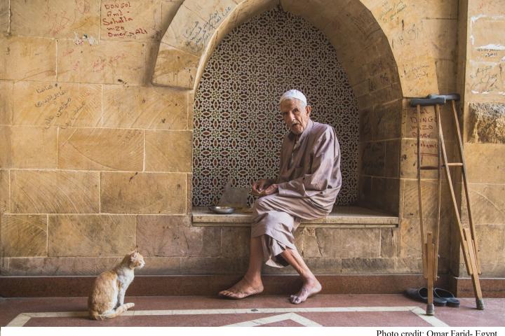 Older person sitting on the street