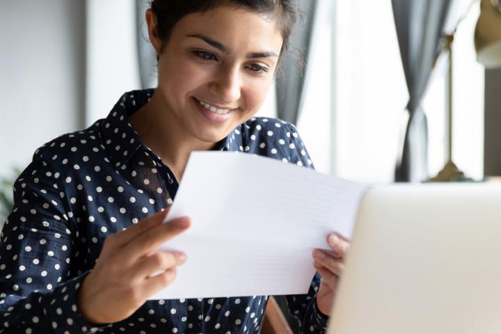 Woman smiling while reading document